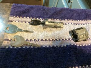 A purple towel with some keys and a key hole
