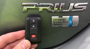 A person holding a key to the prius hybrid.